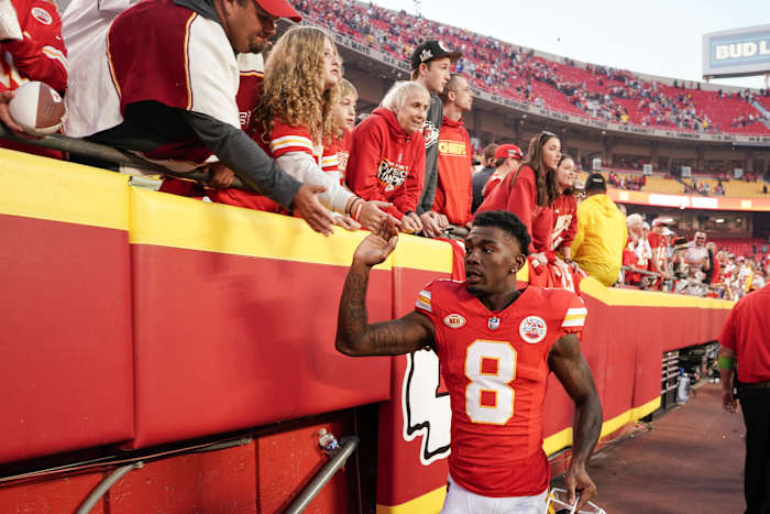 Justyn Ross high fives fans in the stadium